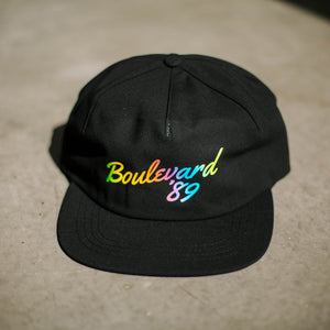 A black cap with rainbow lettering that says, "Boulevard '89".
