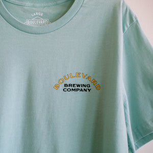 The fron t of a light blue t-shirt that says Boulevard Brewing Company in the upper right side.
