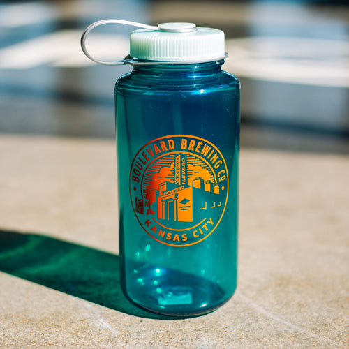 A teal plastic nalgene water bottle with a orange logo of the brewery