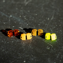 Load image into Gallery viewer, All four colors of the Beer Mug Earrings staggered against a black background.
