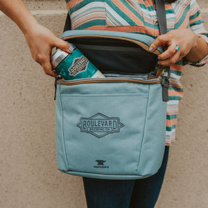 Light blue cooler unzipped with 32oz crowler.