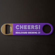 Load image into Gallery viewer, purple paddle style bottle opener with &quot;CHEERS! BOULEVARD BREWING CO&quot;
