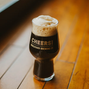 A glass full of a dark beer that says, "CHEERS! Boulevard Brewing Co."