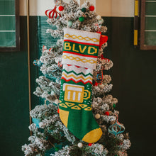 Load image into Gallery viewer, A BLVD Holiday Stocking hanging on a decorated Christmas Tree.
