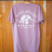 Load image into Gallery viewer, The back of a light purple t-shirt, featuring a white brewery logo.
