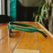 Load image into Gallery viewer, A side view of the green Boulevard Sunglasses.
