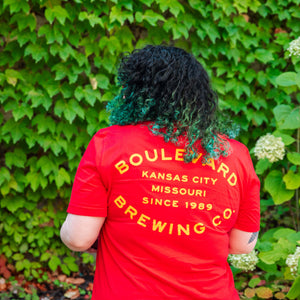 The back of the girl modeling the red barrel stamp tee