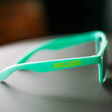 Load image into Gallery viewer, The ride side arm of the Boulevard Mint suglasses, featuring the word, &quot;Boulevard&quot; in yellow lettering.
