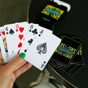 A hand holding some playing cards.