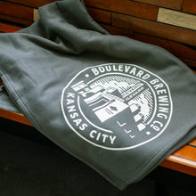 Load image into Gallery viewer, folded hunter green blanket with &quot;BOULEVARD BREWING CO KANSAS CITY&quot; and brewery image in white ink

