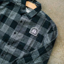 Load image into Gallery viewer, A closeup of the smokestack arch logo on the Arch Lagerman Check Button-Up
