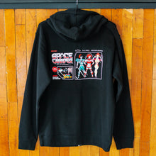 Load image into Gallery viewer, Black hoodie with graphic designs on the back against a wooden panel background
