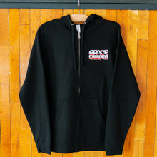 Load image into Gallery viewer, Black hoodie with a logo on a wooden background
