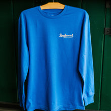 Load image into Gallery viewer, Blue long-sleeve shirt with 'Boulevard' logo on a hanger against a green wall.
