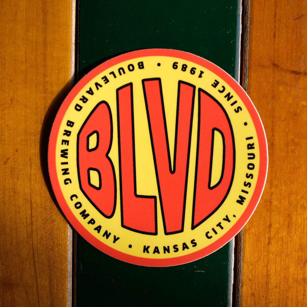 A red and yellow circular sticker.