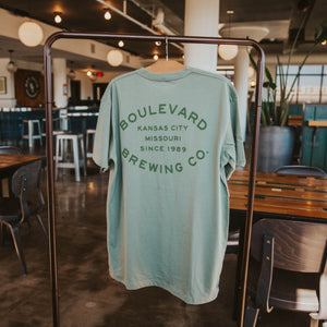 The back of a sage green t-shirt with green lettering that says, "Boulevard Brewing Co., Kansas City, Missouri, since 1989".