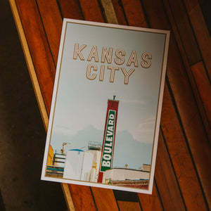 Kansas City Boulevard Smokestack poster laying on wood.