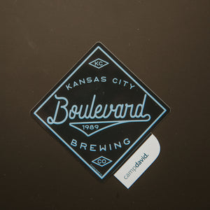 Navy diamond shaped sticker with " Kansas City Boulevard 1989 Brewing Co"