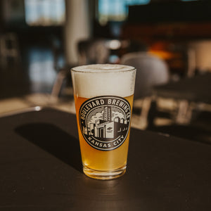 Pint glass with Boulevard Brewing Co. circle logo filled with beer