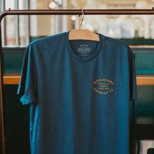 Load image into Gallery viewer, The front of an indigo t-shirt with  a small  hit of gold lettering that says, &quot;Boulevard Brewing Co., Kansas City, Missouri, since 1989&quot;.
