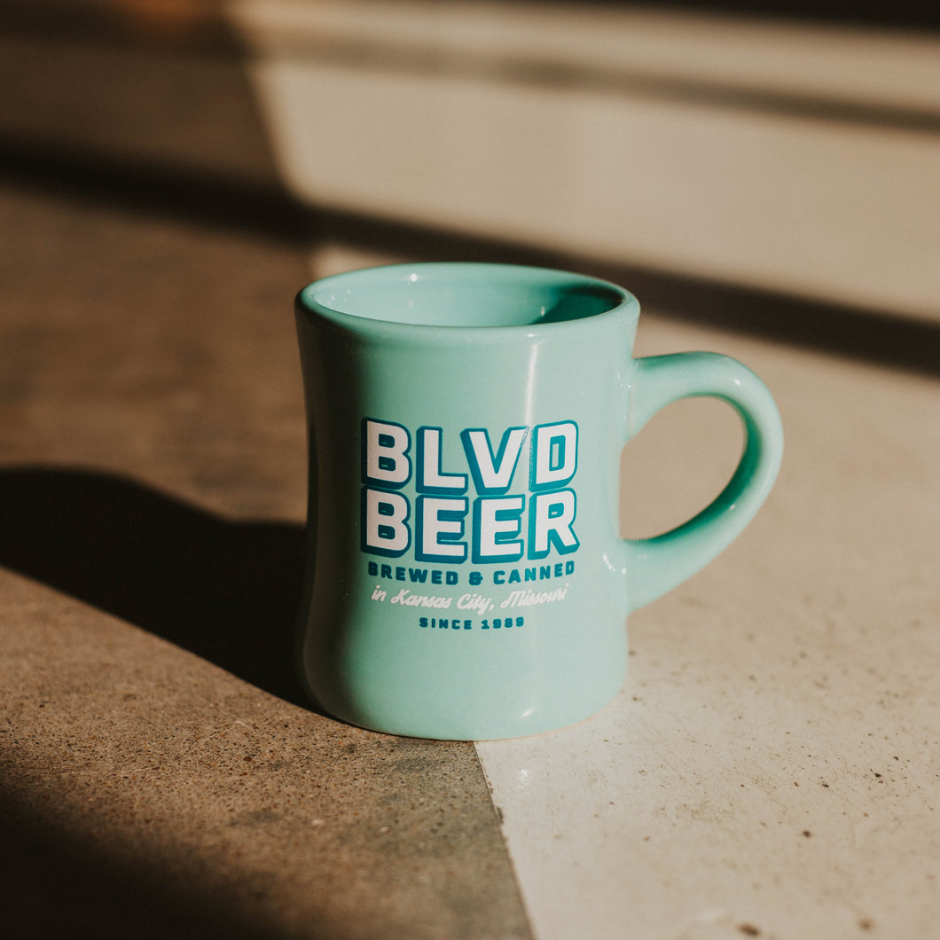 A teal mug that says BLVD BEER