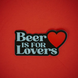 A black sticker that says, "Beer is for Lovers" in a white font with a red heart, against a red background.