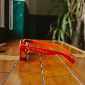 The side view of the red Boulevard Sunglasses.